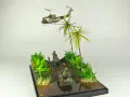Diorama featuring a damaged M113 armored personnel carrier towing by an elephant and the Bell UH-1B helicopter flying over them - photo No. 2