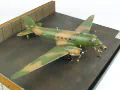 The photo shows a plastic model of the American AC-47 Spooky air support aircraft from the Vietnam War period. Photo No. 8